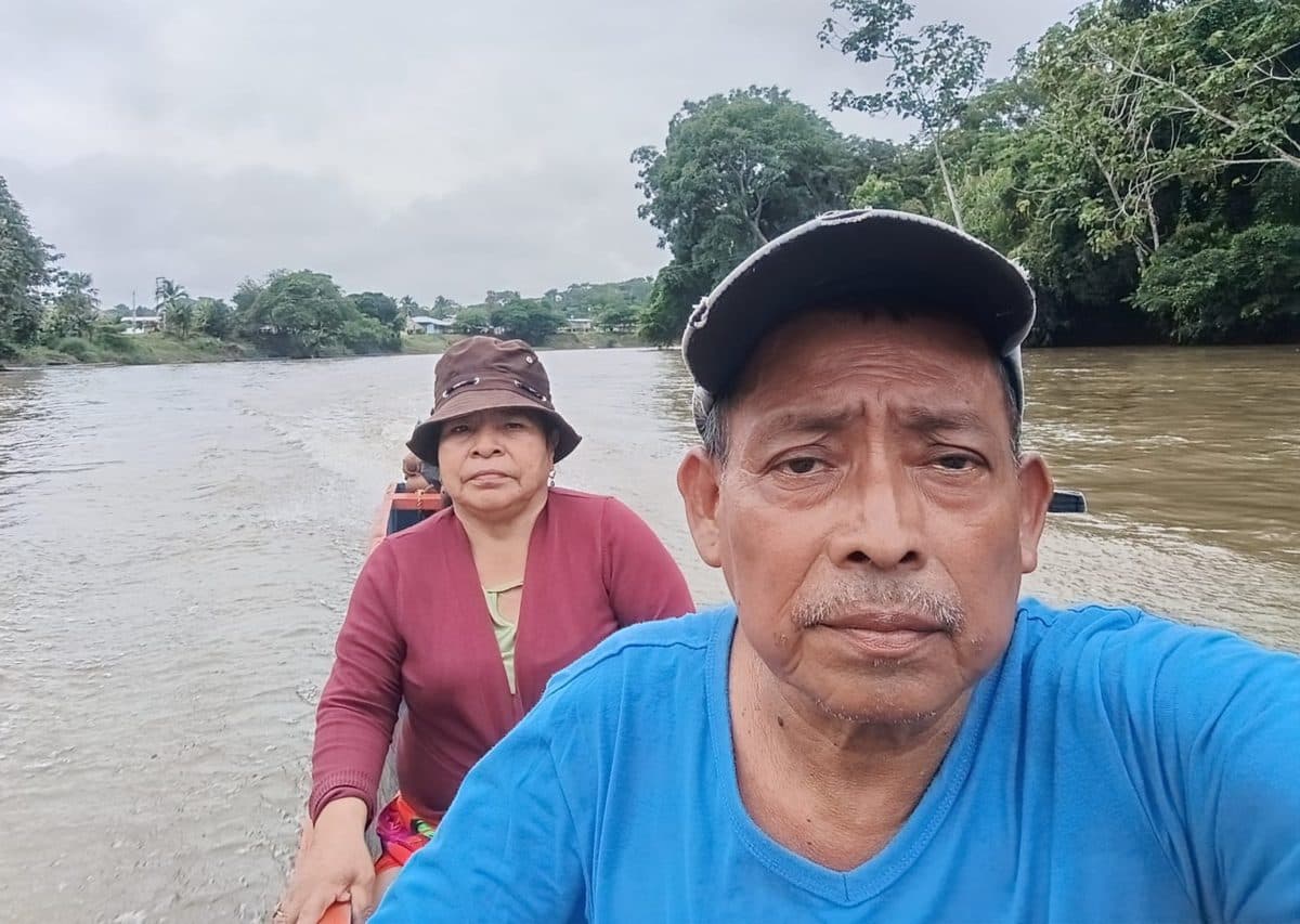 Ricardo and Argelida traveling by dugout canoe on a river in the Darien, Panama